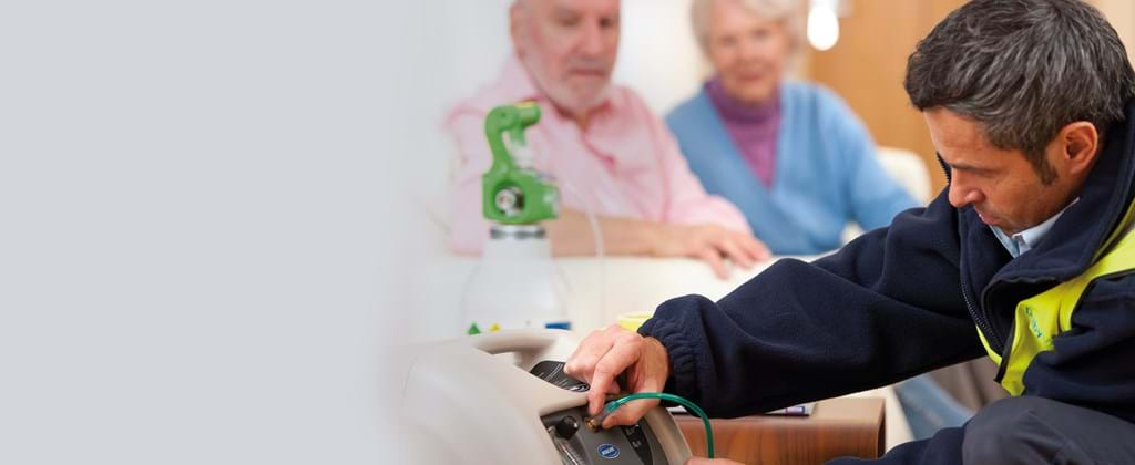 Dolby Vivisol technician installing oxygen device to elderly couple in their home